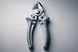 Close-up of a pair of heavy-duty wire cutters on a neutral gray surface