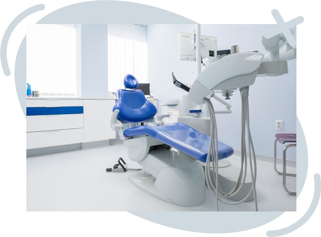 Modern dental clinic room with blue dental chair and equipment