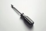 Gray Phillips-head screwdriver on a light surface, shown at an angle with soft shadows.