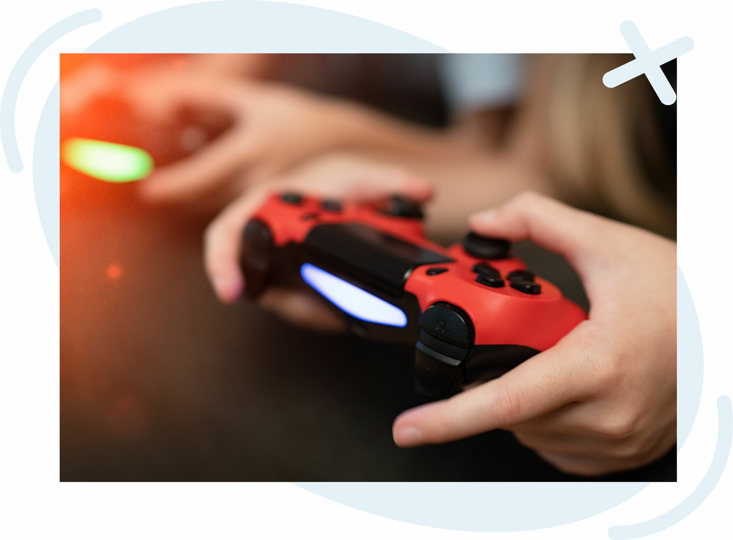 Close-up of hands holding a red game controller while playing a video game.