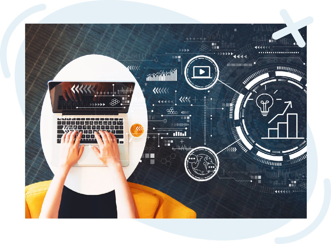 Top-down view of hands typing on a laptop at a round white table with a cup of coffee, overlaid with futuristic digital interface graphics showing charts, arrows, a play icon, a globe, and a lightbulb with an upward graph.