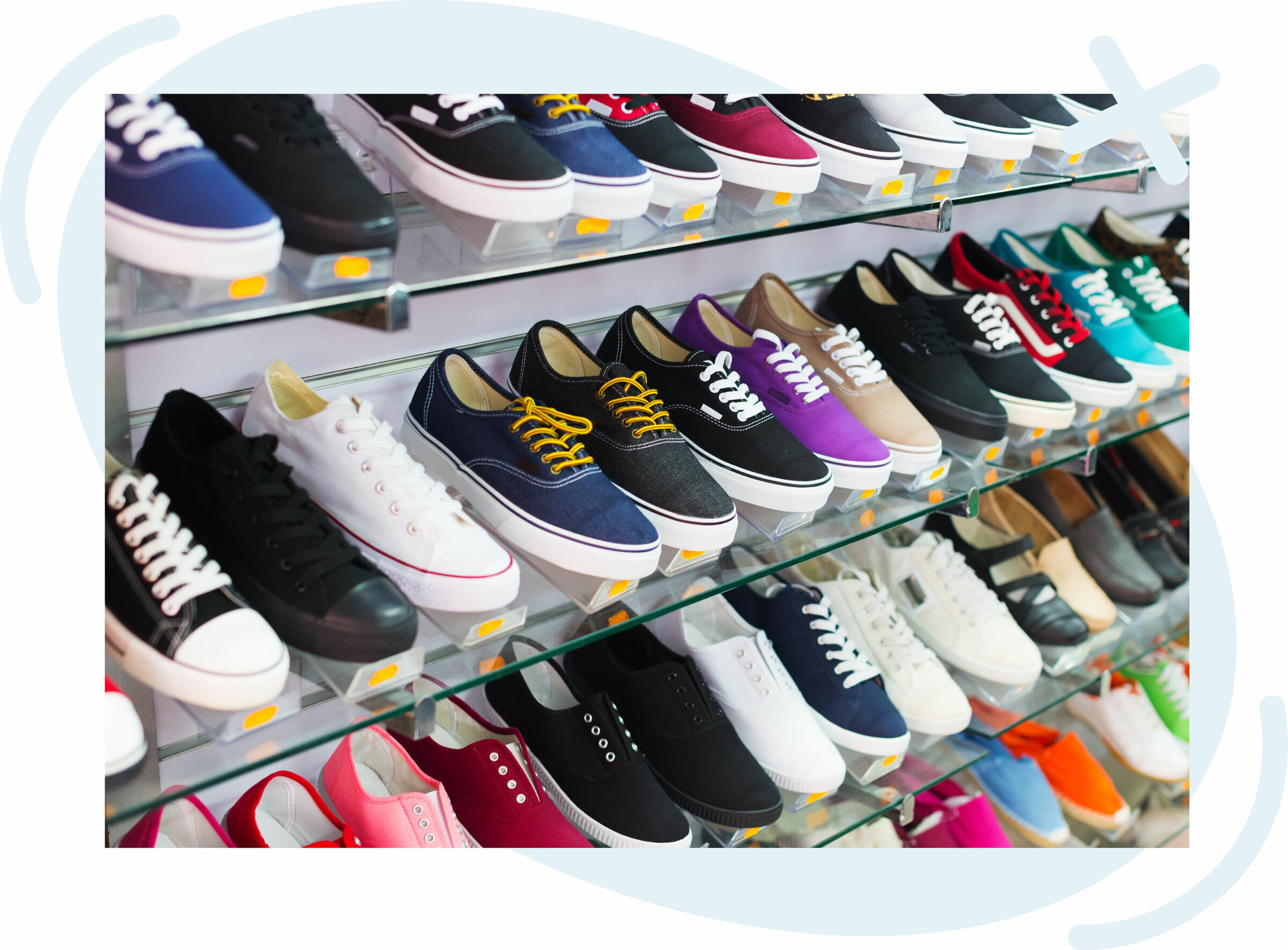 Colorful canvas sneakers displayed on glass shelves in a shoe store