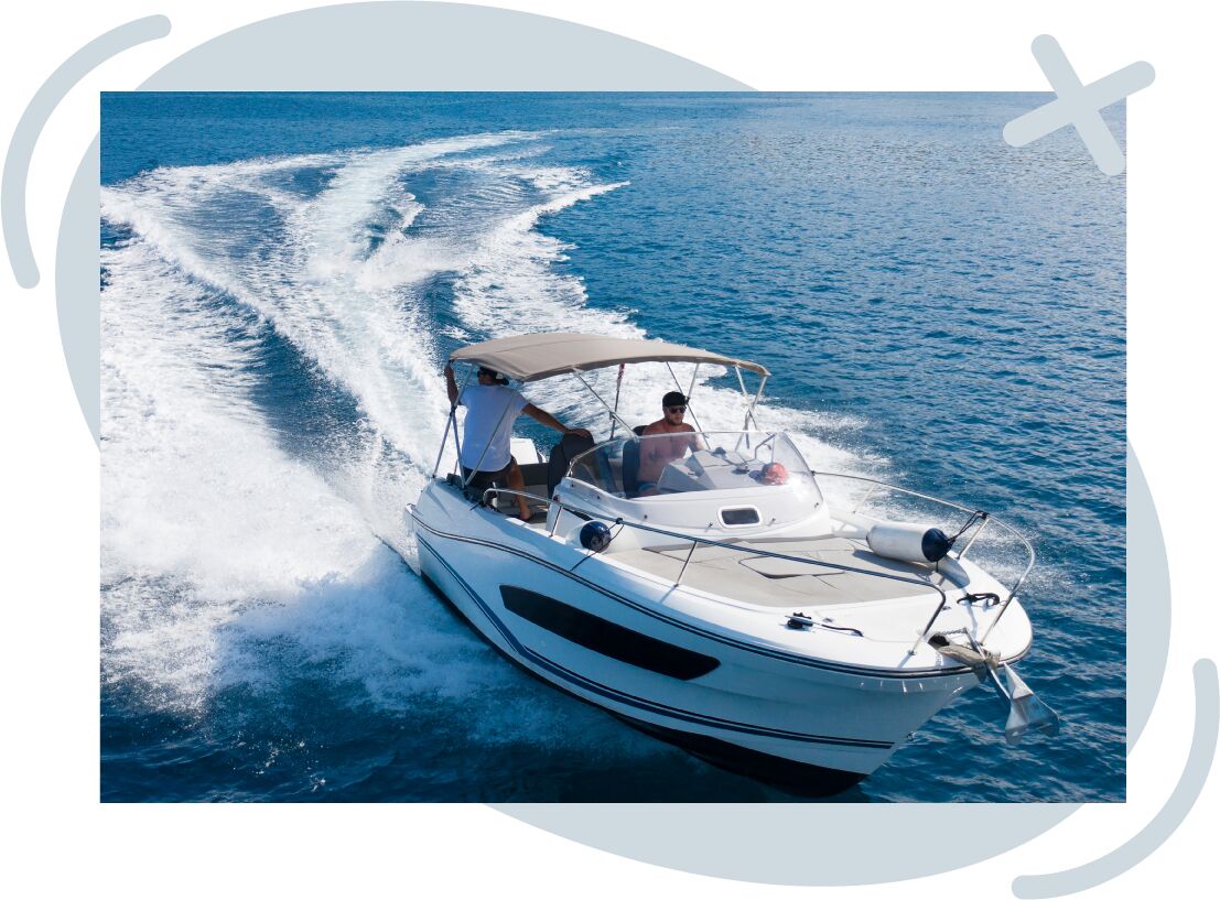 Speedboat cruising on clear blue water, leaving white wakes behind as two people enjoy the ride under a small canopy.