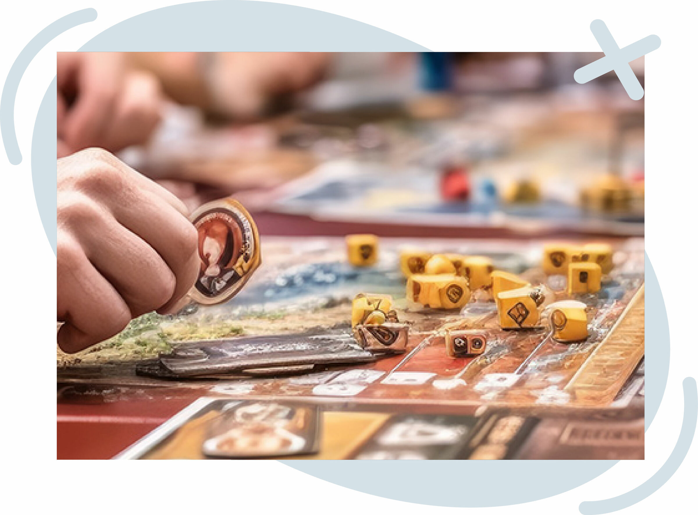 Close-up of hands moving pieces on a colorful board game with yellow dice and tokens scattered across the board.