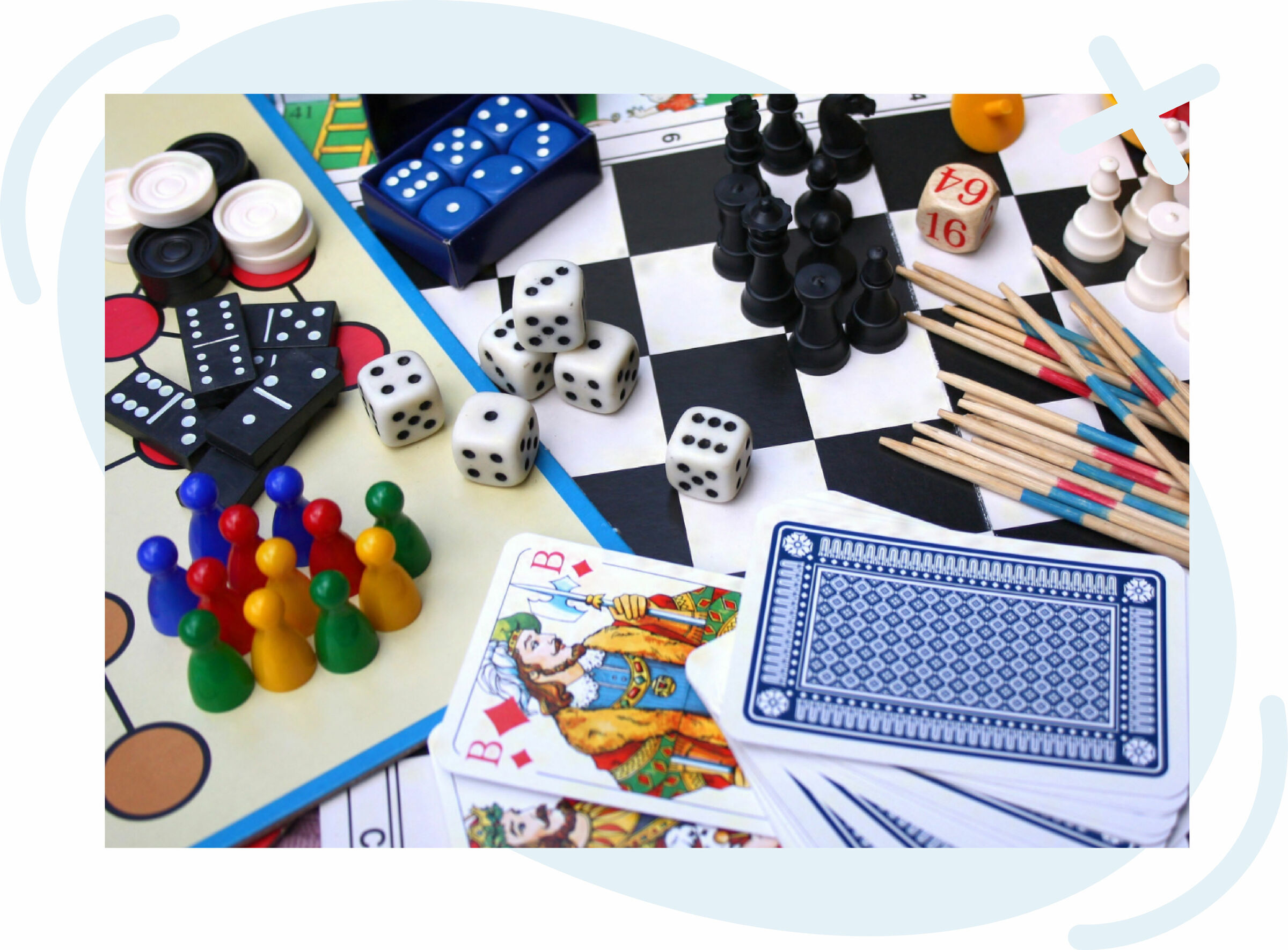 Assorted board and tabletop game pieces and accessories spread out, including chess pieces on a checkered board, dominoes, dice, playing cards, colorful pawns, checkers, and wooden pick-up sticks.