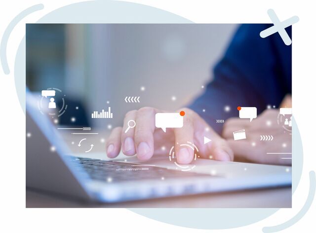 Close-up of hands typing on a laptop with floating digital interface icons overlaid