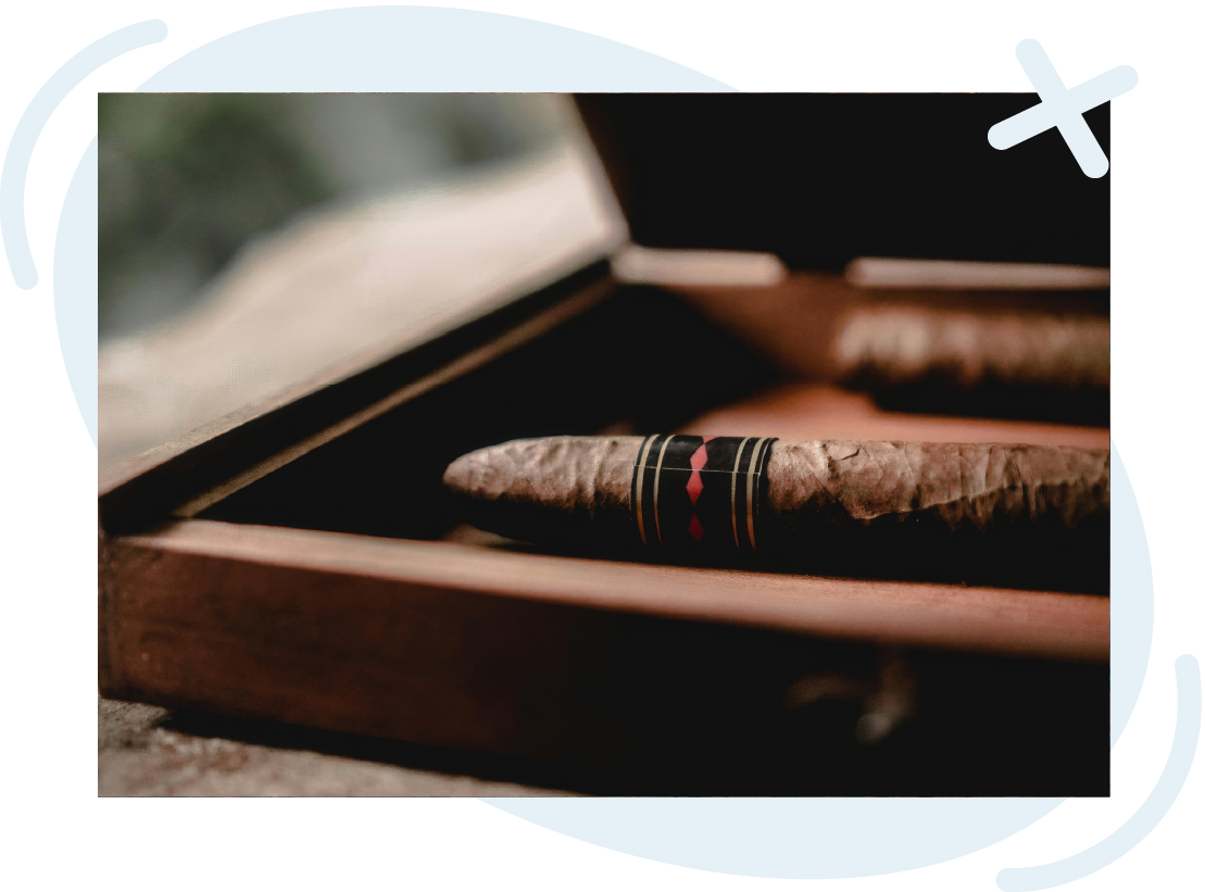 Close-up of premium cigars in a wooden humidor at a cigar shop