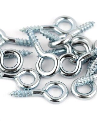 Pile of shiny metal screw eye hooks on a white background