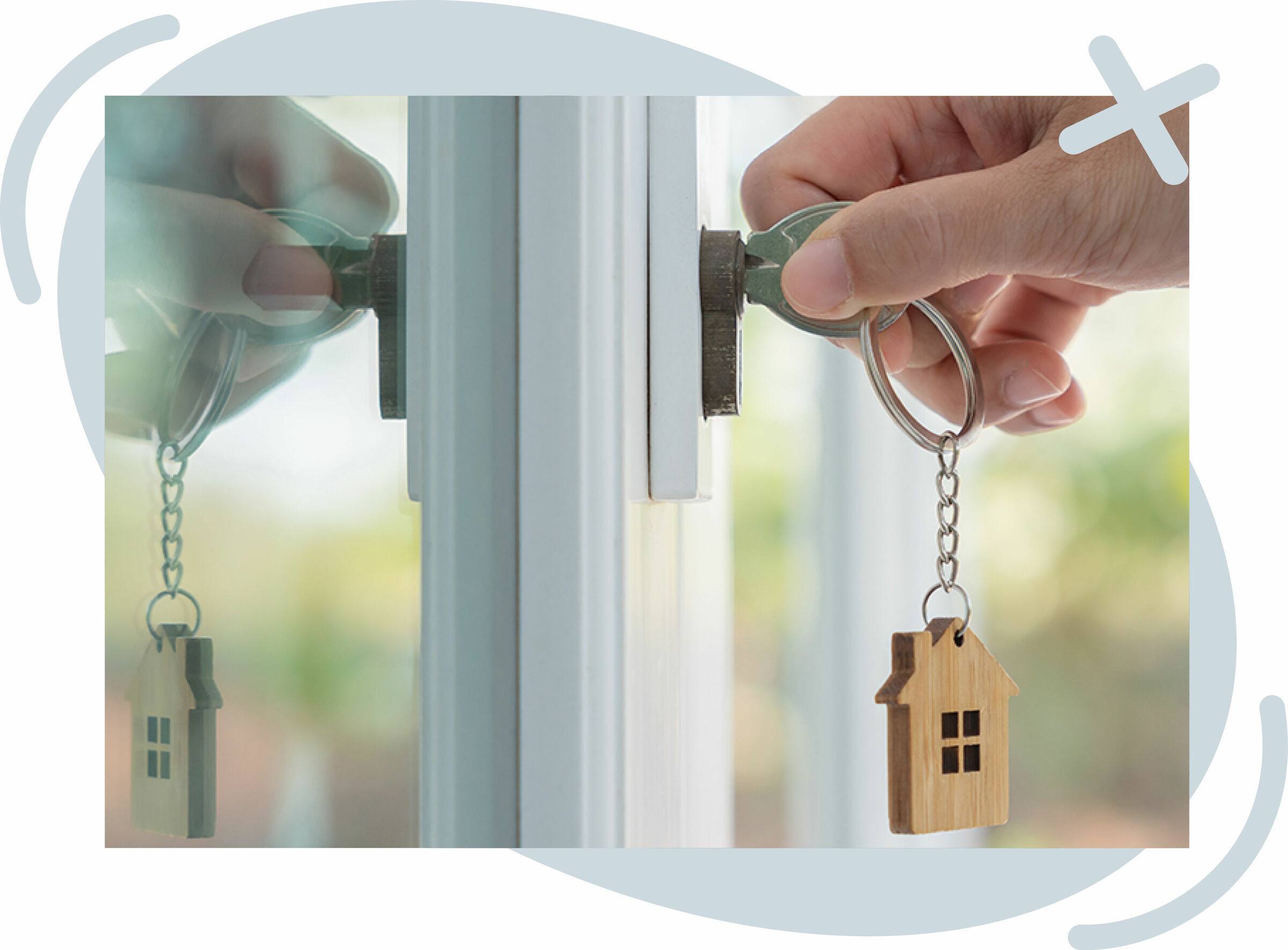 Close-up of a hand turning a key in a door lock, with a wooden house-shaped keychain dangling from the key ring and the scene reflected in the glass.