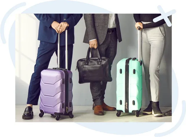 Three people standing with rolling carry-on suitcases and a briefcase, showing only their lower bodies and luggage.
