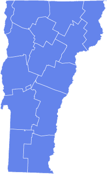 Blue silhouette map of Vermont showing county boundaries in white lines.