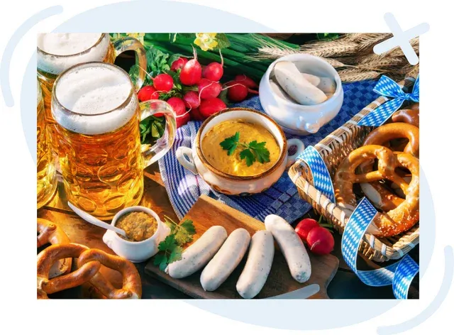 Traditional German meal spread with beer, white sausages, pretzels, mustard, and radishes on a rustic table