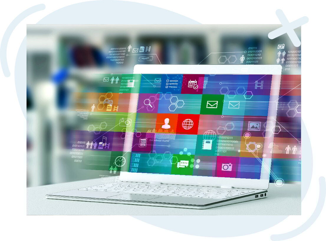 Open laptop with colorful app tiles and translucent tech icons floating across the screen, representing digital communication and data flow in a modern office setting.
