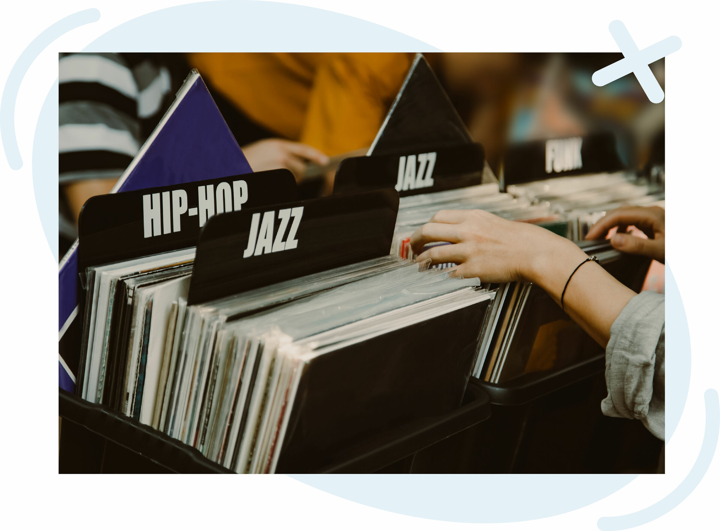 Hands flipping through vinyl records in a store, browsing sections labeled Hip-Hop, Jazz, and Funk.