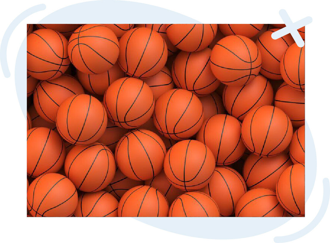 Pile of bright orange basketballs with black seams filling the frame.