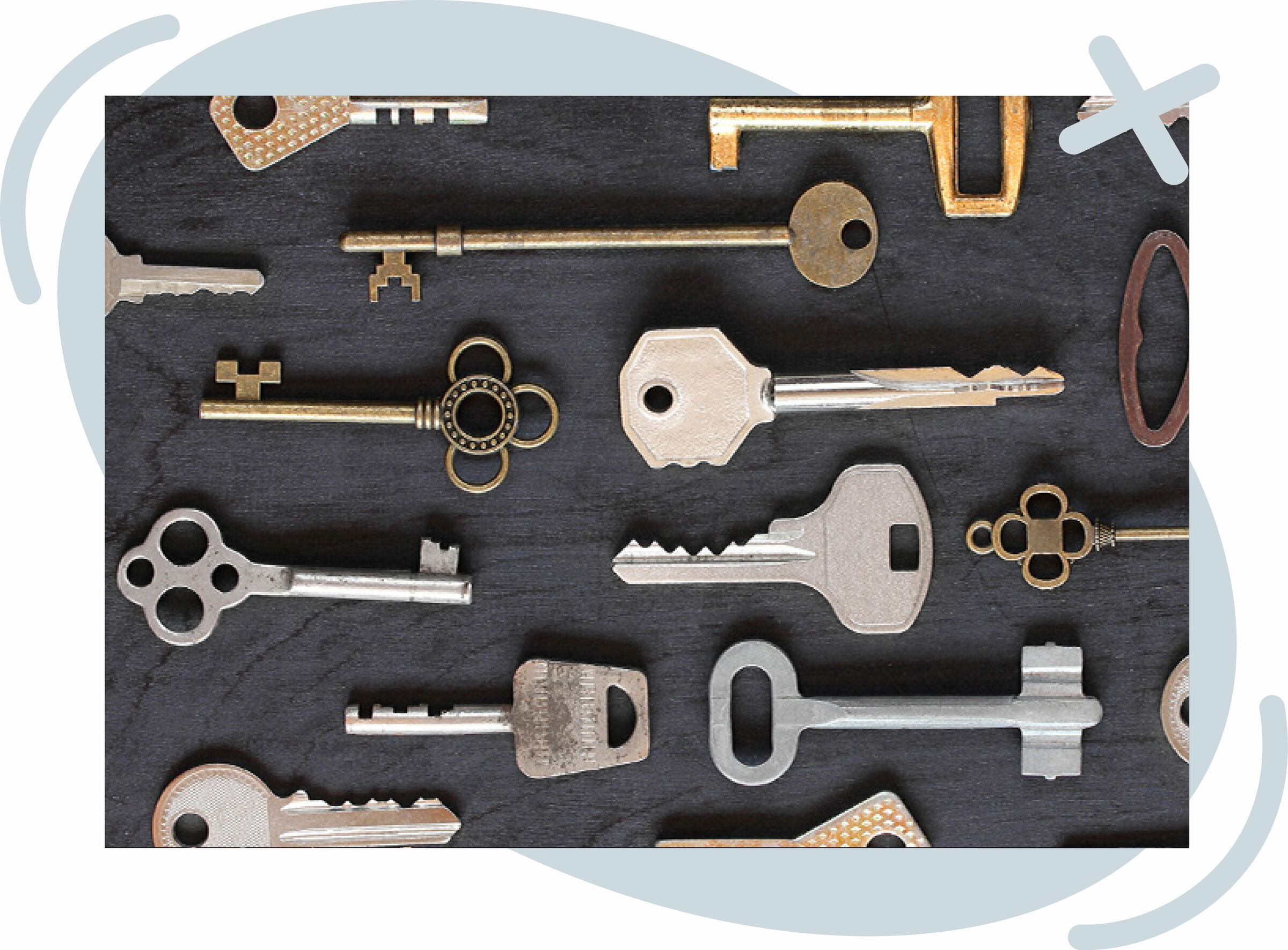 Assorted vintage and modern metal keys arranged neatly on a dark surface.