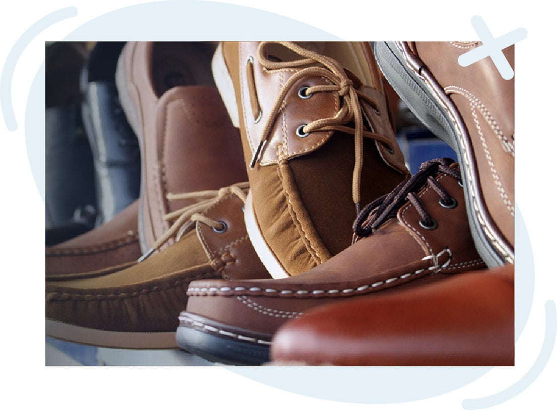 Close-up of assorted brown leather casual shoes with visible stitching and laces displayed together.