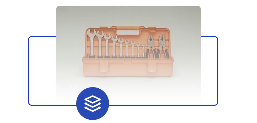 Illustration of an open toolbox filled with assorted hand tools, framed by a blue outlined bracket and a layered-stacks icon at the bottom.