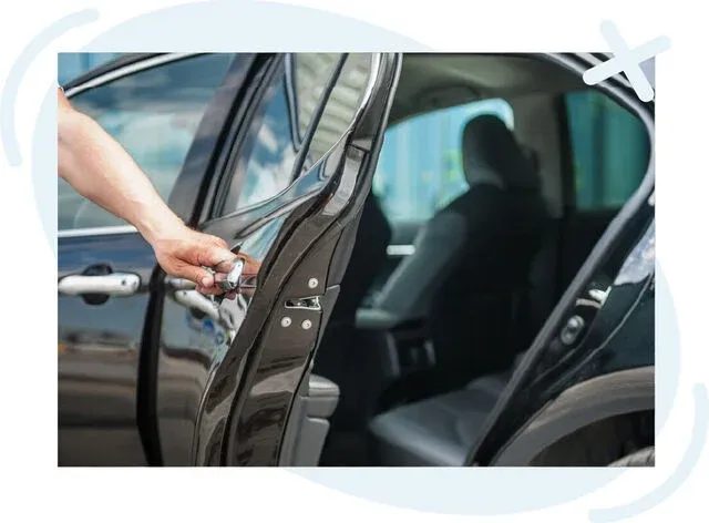 Close-up of a person’s hand opening the rear passenger door of a black car, revealing the interior seats.