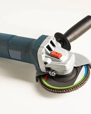 Close-up of an angle grinder with a side handle and abrasive disc on a white background.