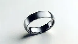 Minimalist silver metal ring on a light background